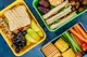 sandwiches and fruit in a packed lunch
